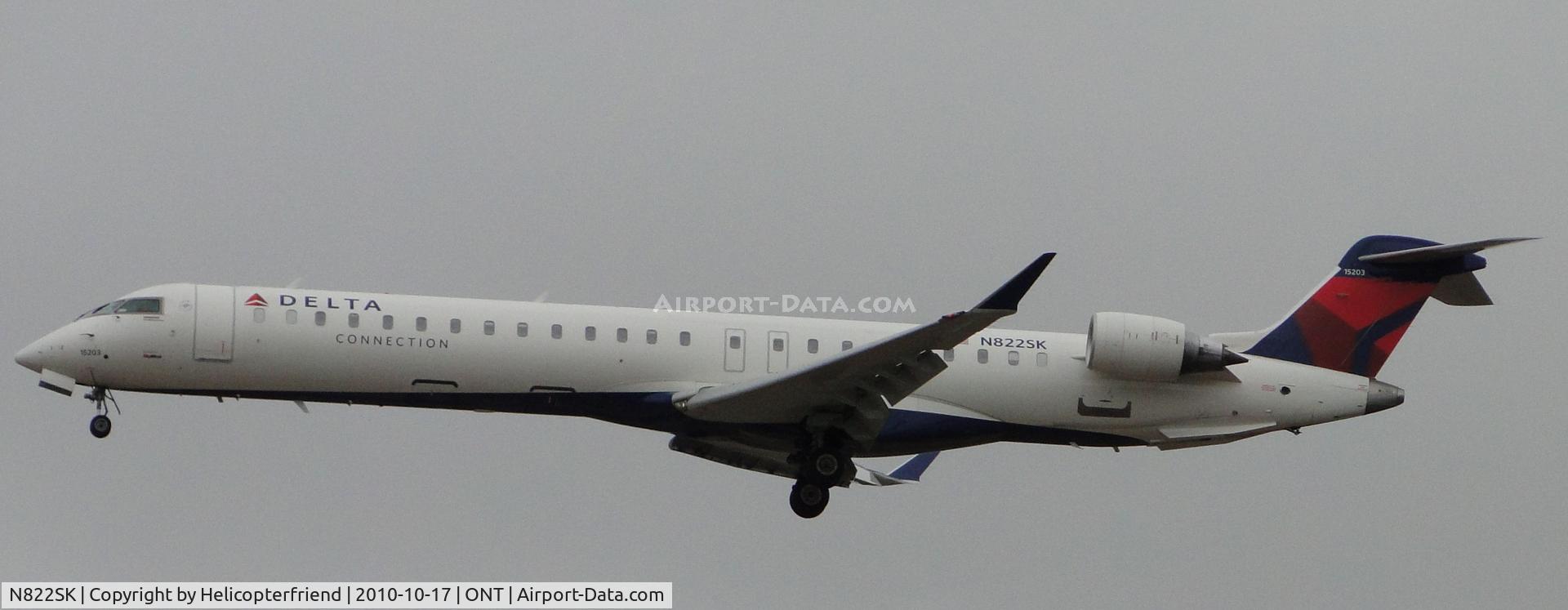 N822SK, 2008 Bombardier CRJ-900ER (CL-600-2D24) C/N 15203, On final to runway 26R on an overcast day with mist