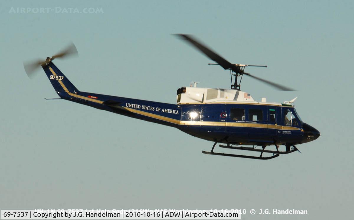 69-7537, 1969 Bell UH-1N Iroquois C/N 31078, over flying NAF ramp