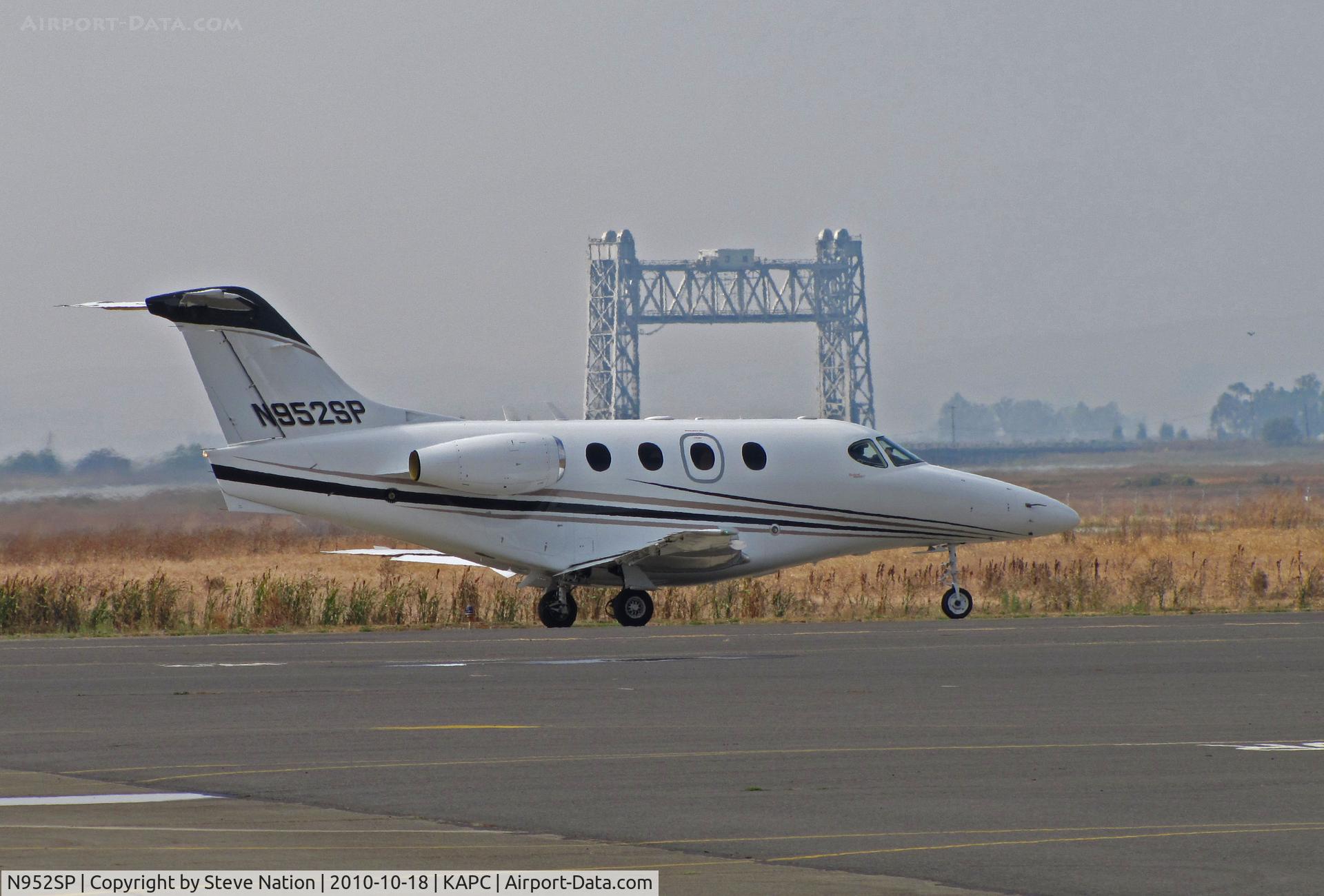 N952SP, Hawker Beechcraft Corp 390 C/N RB-260, Framed by the Napa River RR Bridge, Scannell Citation Inc (Indianapolis, IN) 2008 Hawker Beechcraft Corp 390 taxis out for flight to KHHR (Hawthorne, CA)
