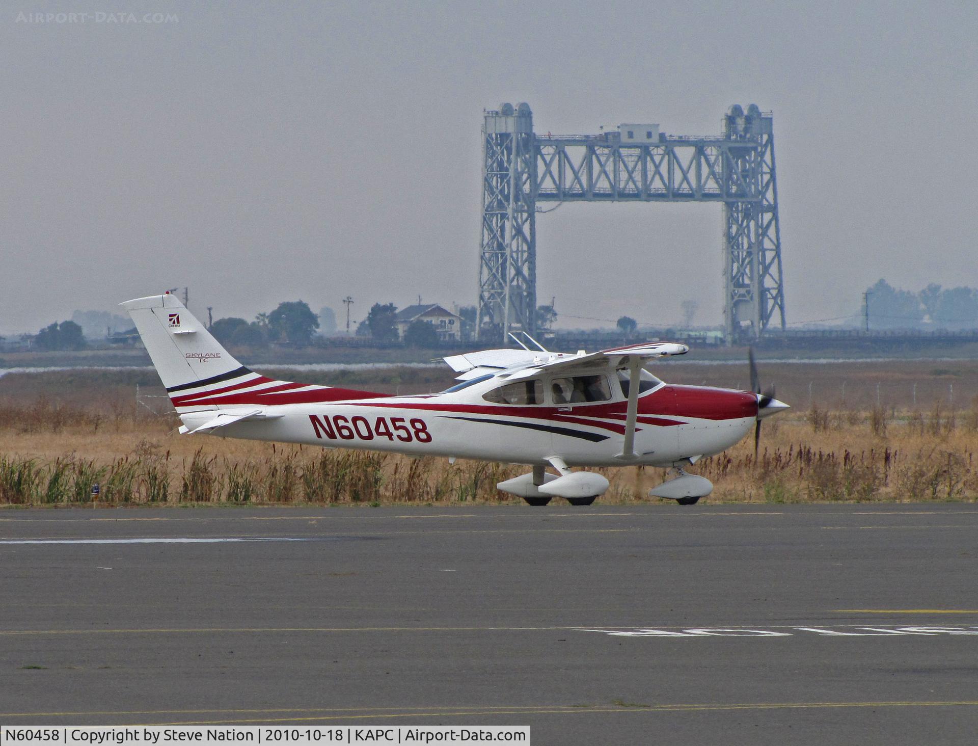 N60458, 2006 Cessna T182T Turbo Skylane C/N T18208574, 2006 Cessna T182T taxis past Napa River RR Bridge for flight home to KMYF (Montgomery Field/San Diego, CA)