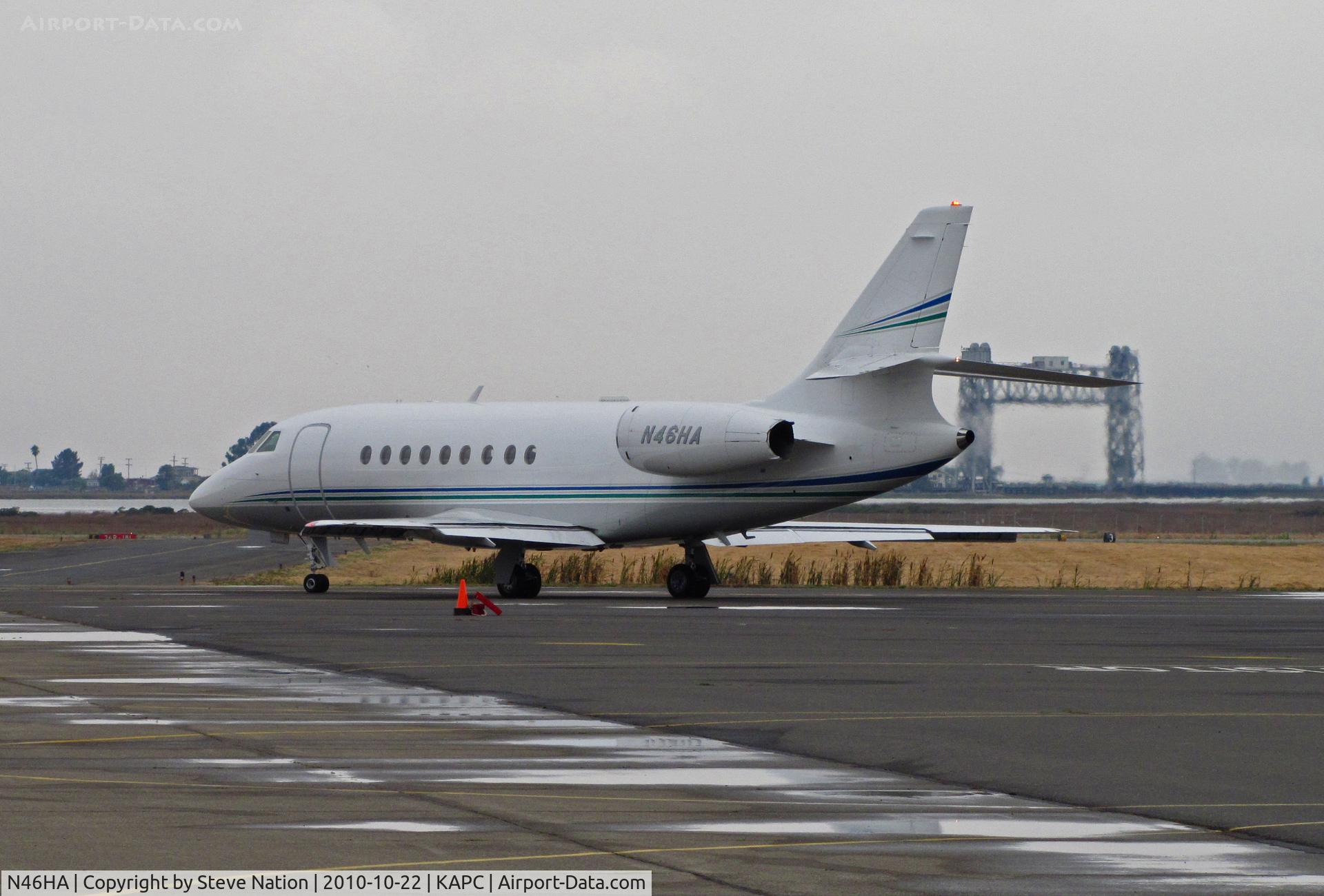 N46HA, 1999 Dassault Falcon 2000 C/N 91, 1999 Falcon 2000 taxis from heavy jet ramp for flight to sunny MMSD (Los Cabos International, Baja California) - Napa River RR Bridge visible