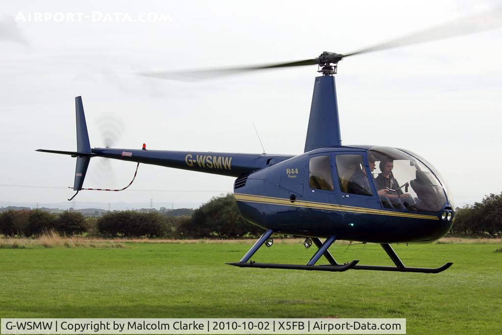 G-WSMW, 2009 Robinson R44 Raven C/N 2068, Robinson R44 Raven lifting off at Fishburn Airfield in October 2010.
