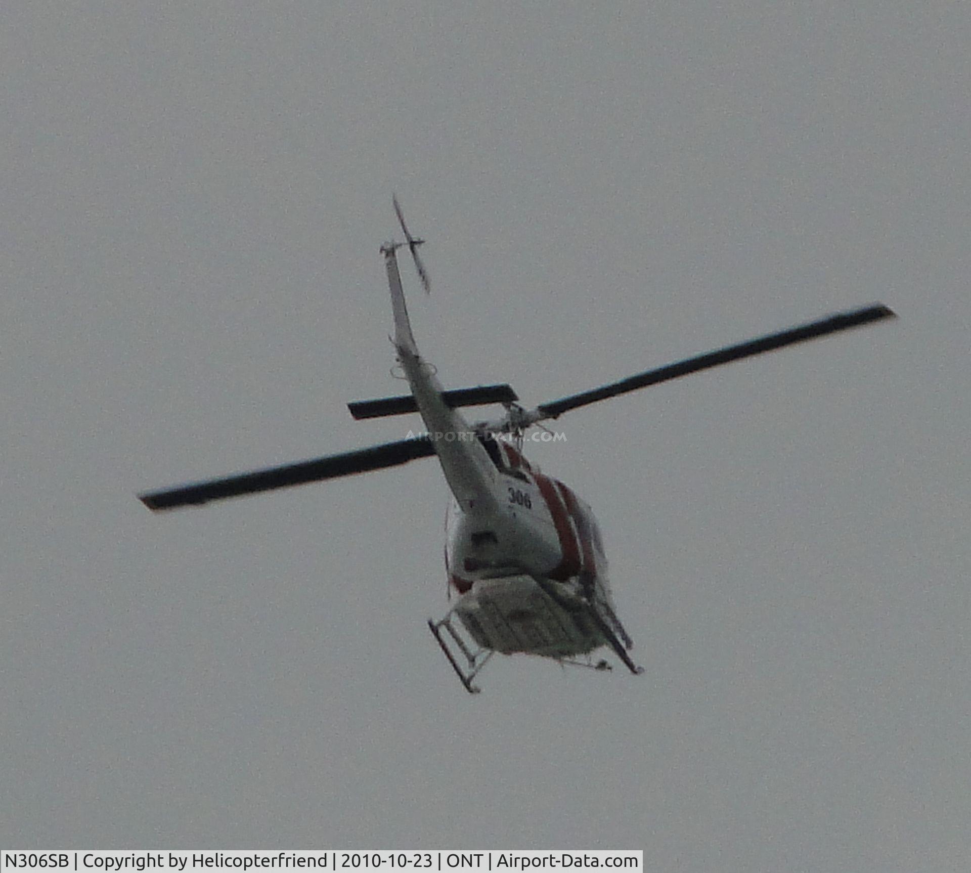 N306SB, 1971 Bell UH-1H Iroquois C/N 13041, Flying southbound over Ontario Airport at about the middle of the field
