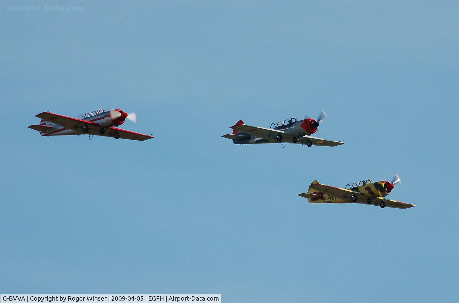 G-BVVA, 1987 Bacau Yak-52 C/N 877610, Leading G-YAKF and G-YFUT over Runway 28