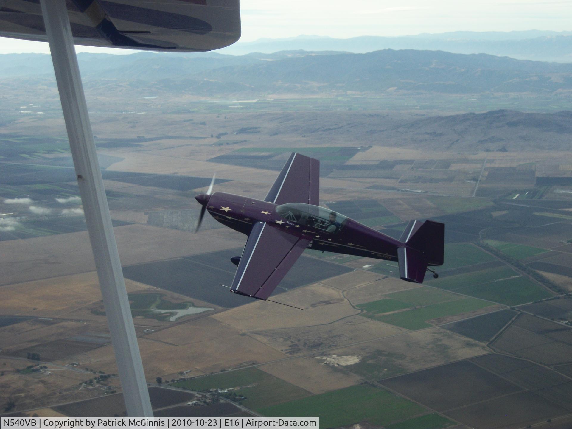 N540VB, Extra EA-300 C/N 033, In formation with an Eagle over Hollister CA.