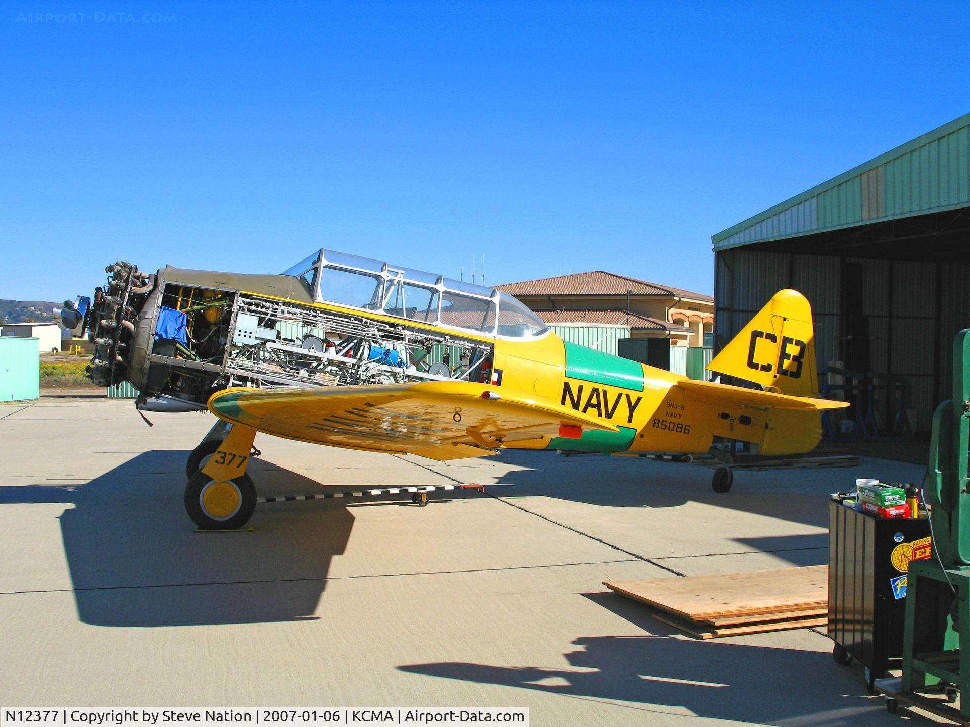 N12377, North American SNJ-5 Texan Texan C/N 85086, North American SNJ-5 BuAer 85096 as CB/377 on Camarillo, CA home ramp on sunny January 2007 day - many panels removed