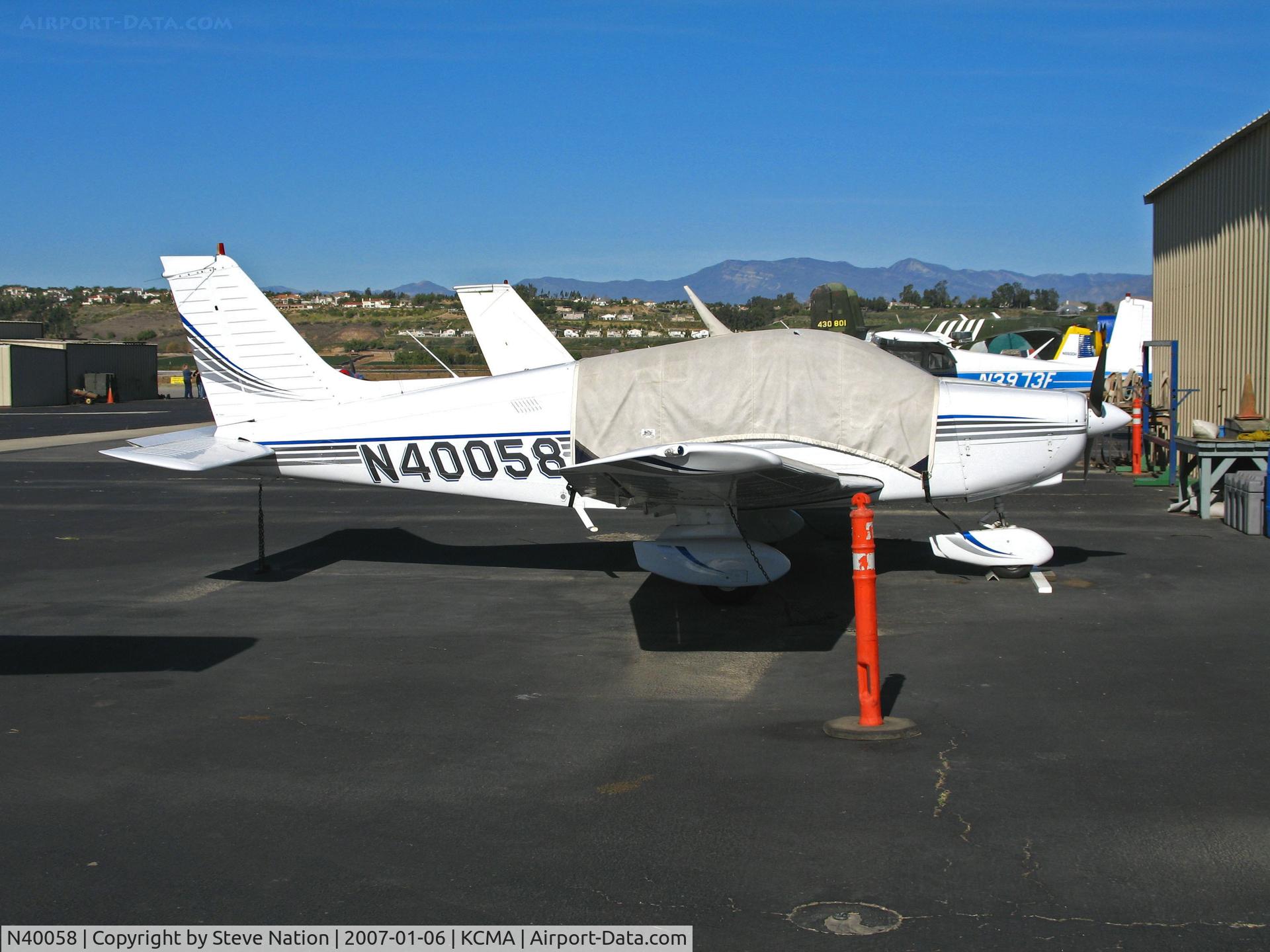 N40058, 1977 Piper PA-28-161 C/N 28-7816007, Behind ubiquitous orange cone and under sunscreen cover lurks this 1977 Piper PA-28-161 at Camarillo Airport (CA) home base on sunny, balmy January day