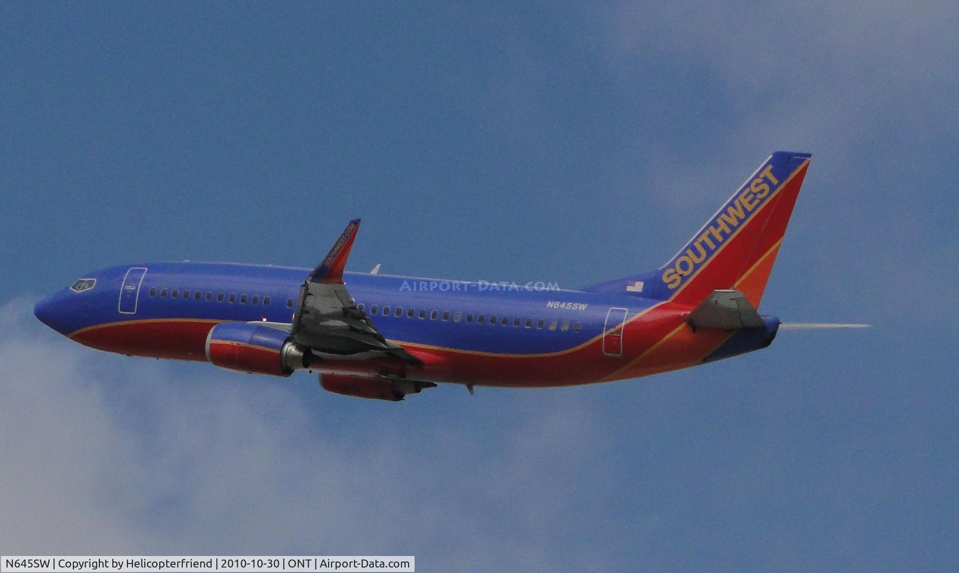 N645SW, 1997 Boeing 737-3H4 C/N 28330, Airbourne and heading westbound after taking off from runway 26R