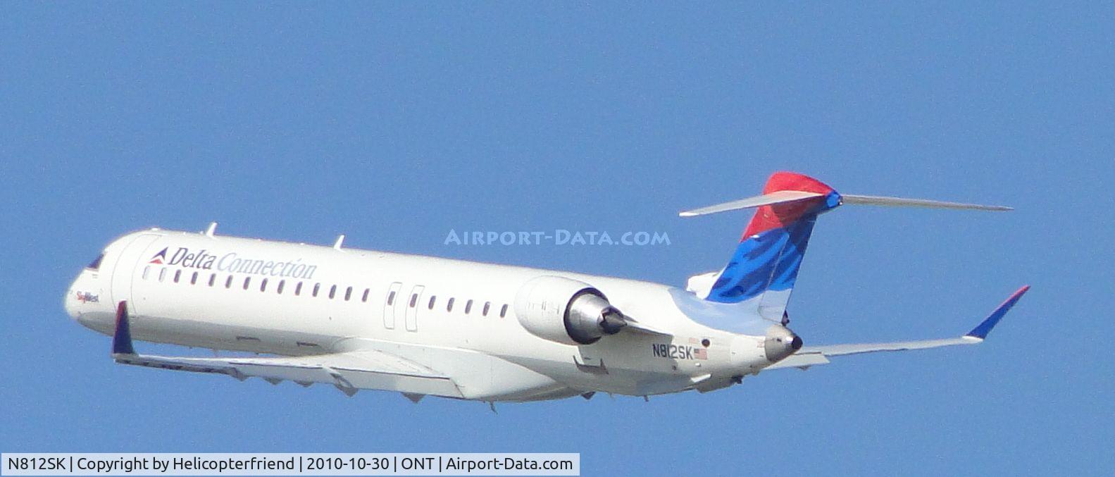 N812SK, 2006 Bombardier CRJ-900ER (CL-600-2D24) C/N 15098, SkyWest Delta Connection climbing out after departing runway 26R