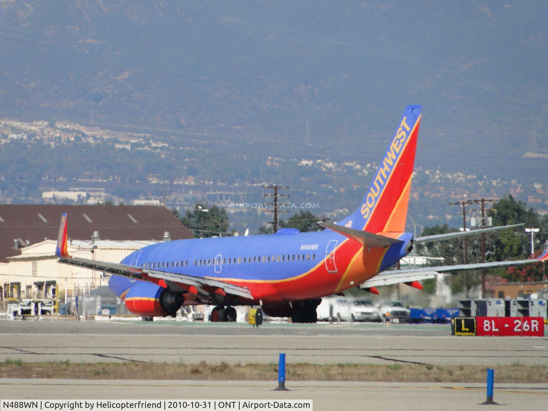 N488WN, 2004 Boeing 737-7H4 C/N 33853, Turning off at taxiway L and heading back to Southwest terminal