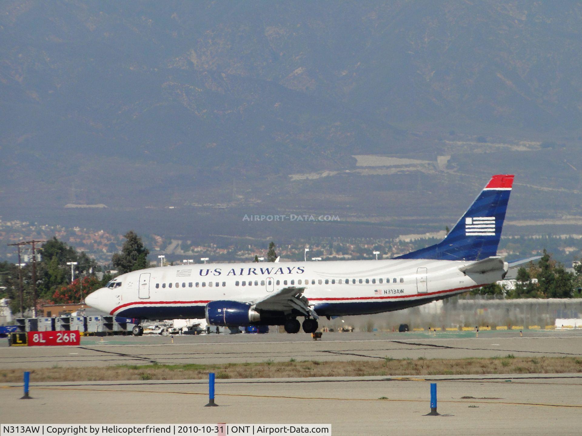 N313AW, 1987 Boeing 737-3S3 C/N 23712, Turning onto taxiway L from runway 26R enroute to U.S. Airways terminal