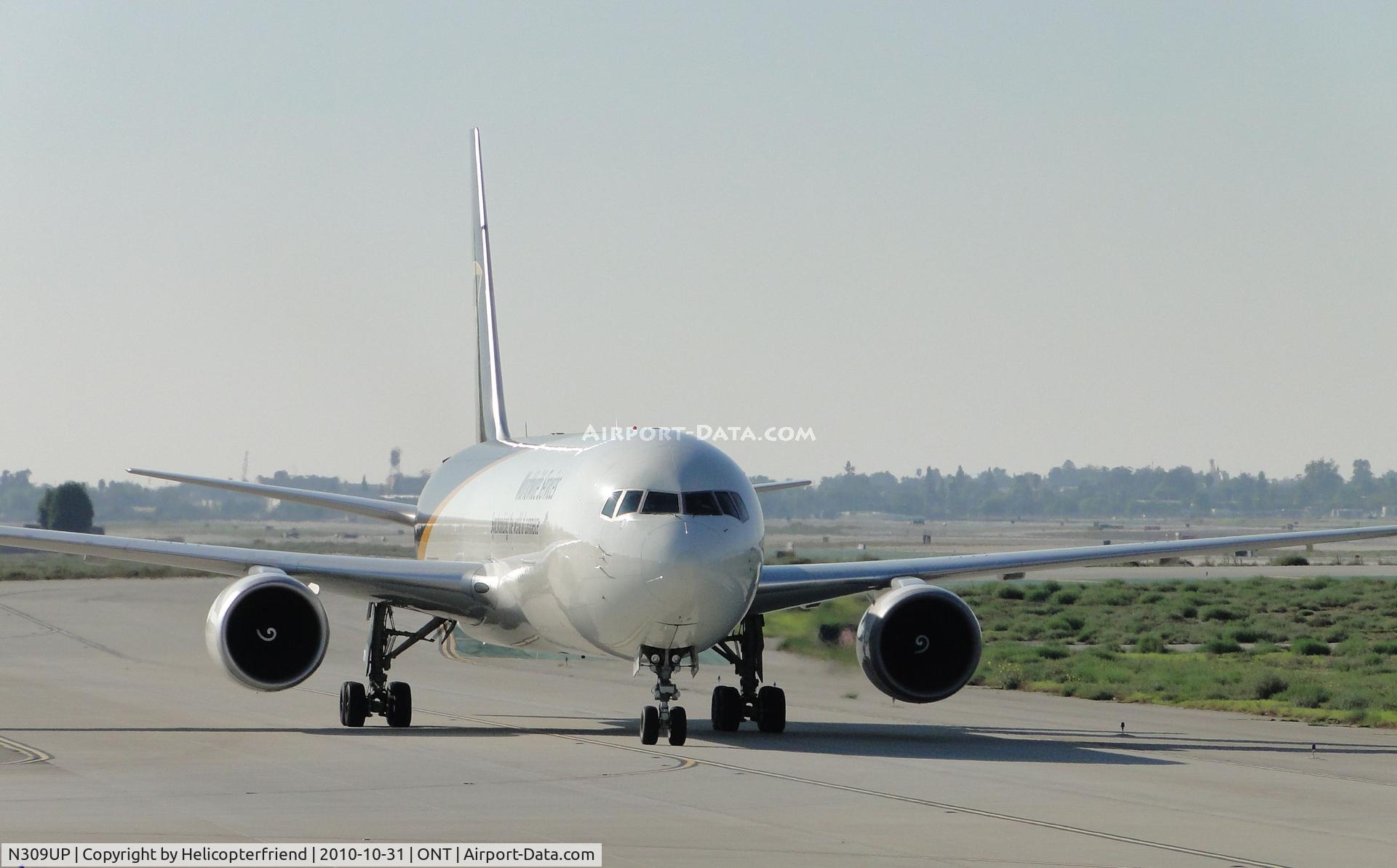 N309UP, 1996 Boeing 767-34AF C/N 27740, Headed eastbound, slowing down to turn south into UPS parking apron