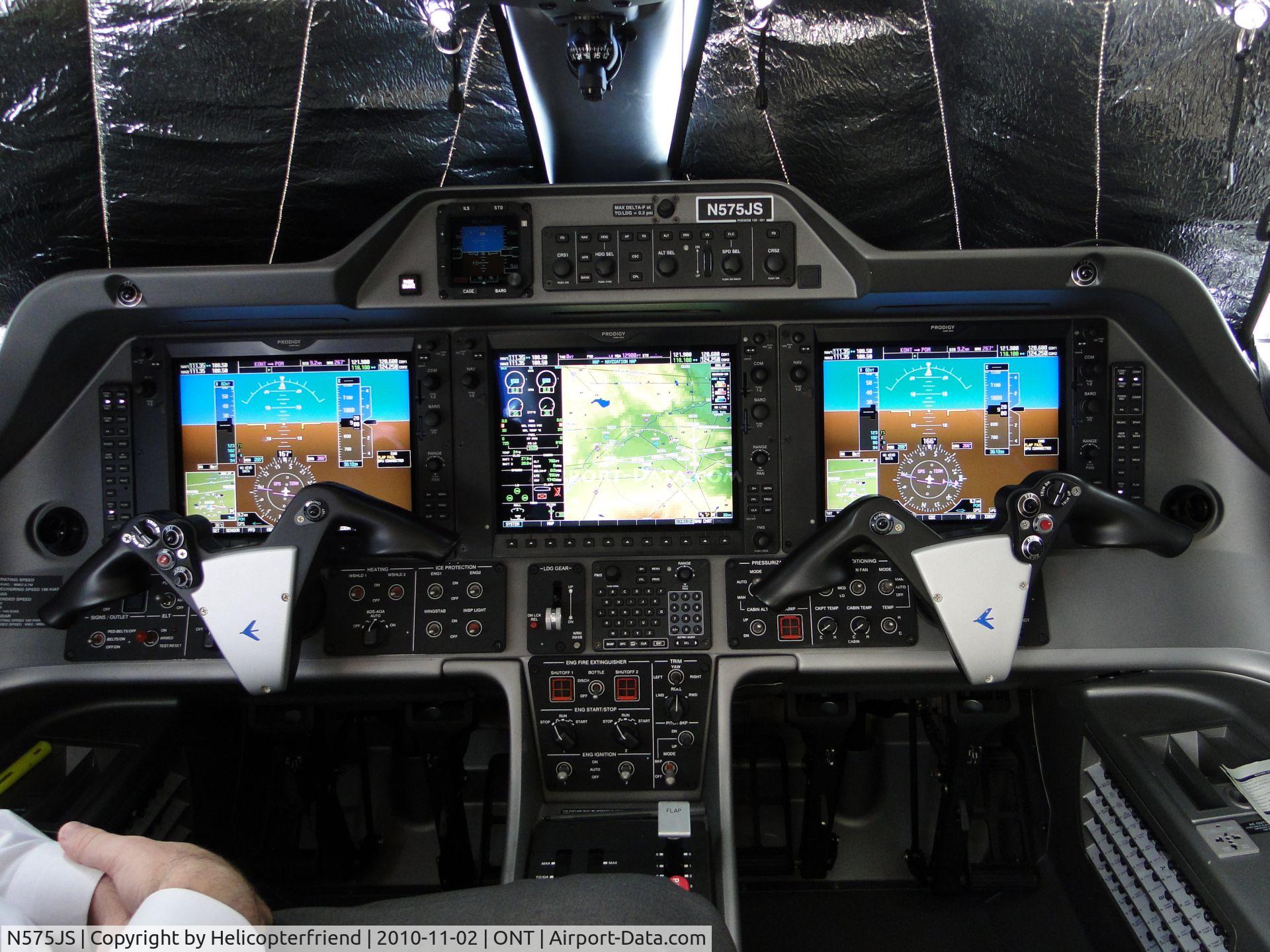 N575JS, 2009 Embraer EMB-500 Phenom 100 C/N 50000051, Cockpit area, checking out the instruments before taking off