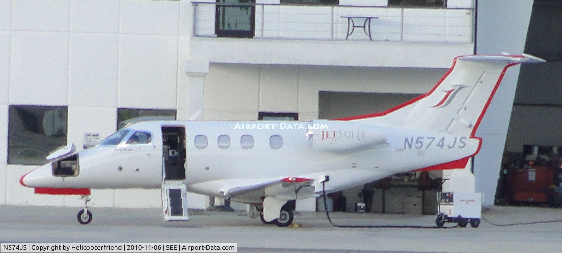 N574JS, 2009 Embraer EMB-500 Phenom 100 C/N 50000046, Parked and electrical cart plugged in near Jet Air Hanger