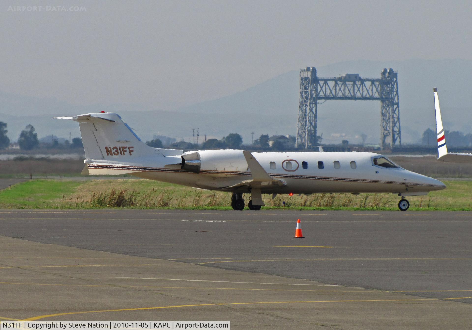 N31FF, Learjet Inc 31A C/N 053, 1992 Learjet 31A operated by Delta Air Elite Biz Jets departs  KAPC/Napa County, CA with Napa River RR Bridge in background for KPHX/Sky Harbor Intl Airport, Phoenix, AZ as 