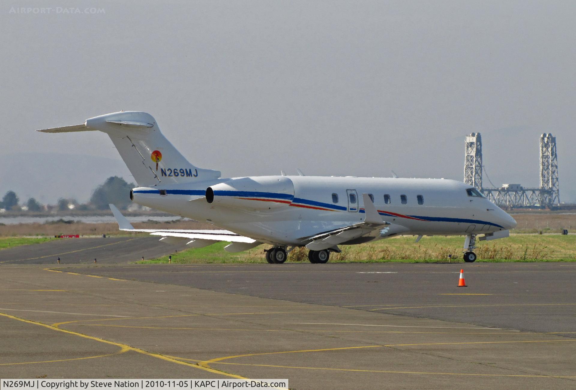 N269MJ, 2007 Bombardier Challenger 300 (BD-100-1A10) C/N 20180, Maui Jim Inc. (Peoria, IL!) 2007 Challenger BD-100-1A10 (parrot tail logo) passes Napa River RR Bridge on way to active RWY