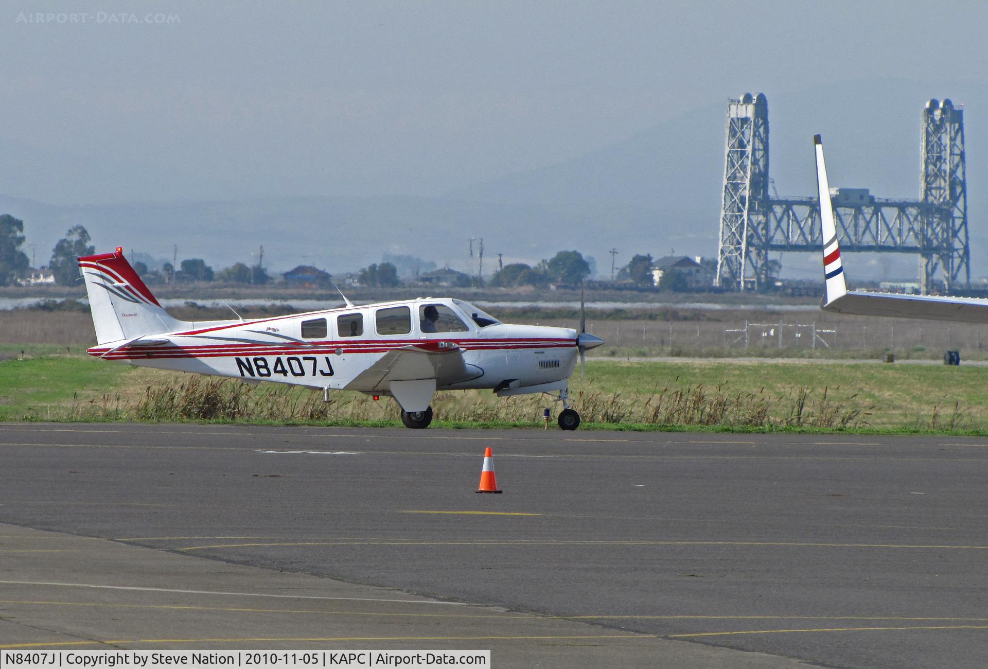 N8407J, Raytheon Aircraft Company A36 Bonanza C/N E-3632, ex-Japan Air Lines A36 Bonanza after maintenance flight - Napa River RR Bridge in background (JAL closed training program with IASCO in October 2010 after nearly 40 years)