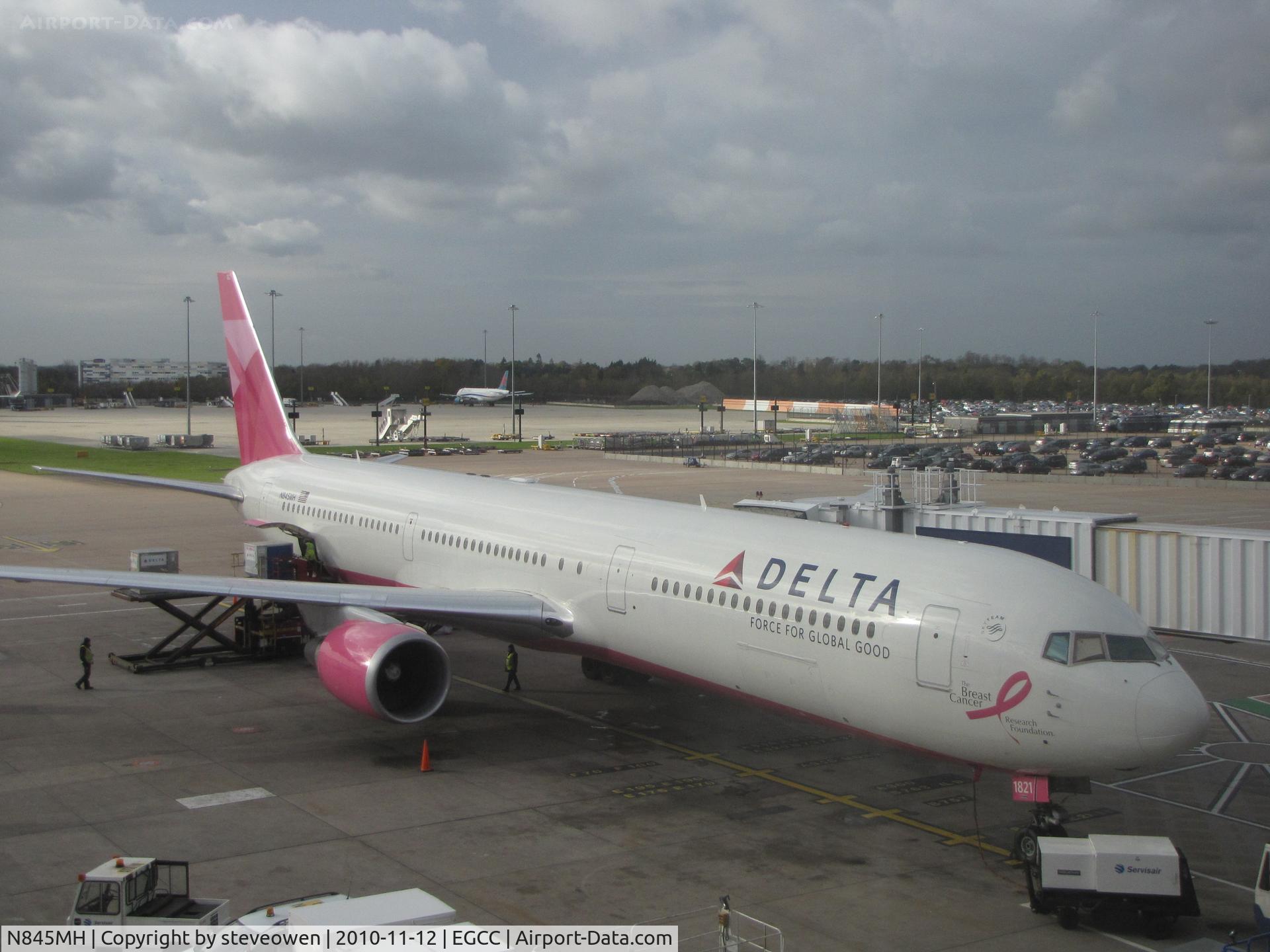 N845MH, 2002 Boeing 767-432/ER C/N 29719, Delta B-767 in Breast Cancer Awareness Colours at Manchester International UK.Taken from inside the terminal building
