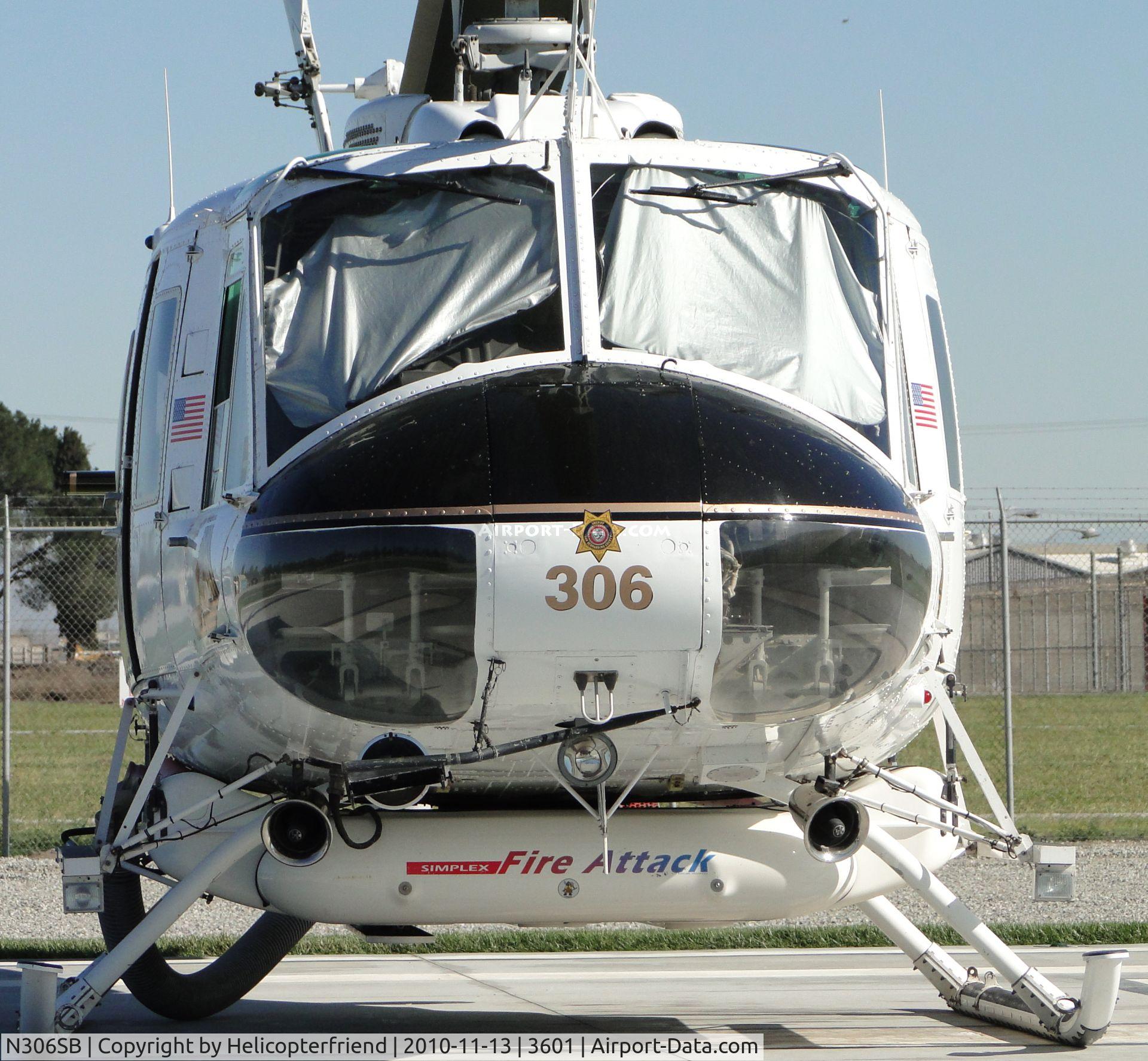 N306SB, 1971 Bell UH-1H Iroquois C/N 13041, Eyes covered up from the sun, Fire Attack tank is approximately 350 - 400 gallons. Note SBSO insignia on nose. Parked at Prado Helitack Base