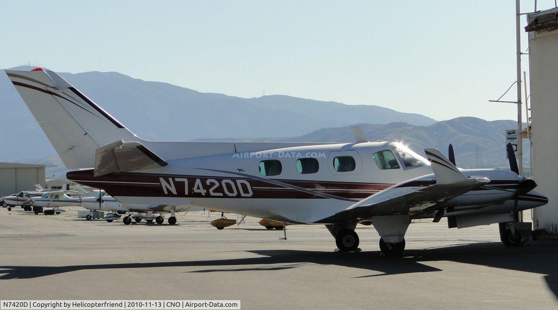 N7420D, 1970 Beech A60 C/N P-134, Parked by a hanger