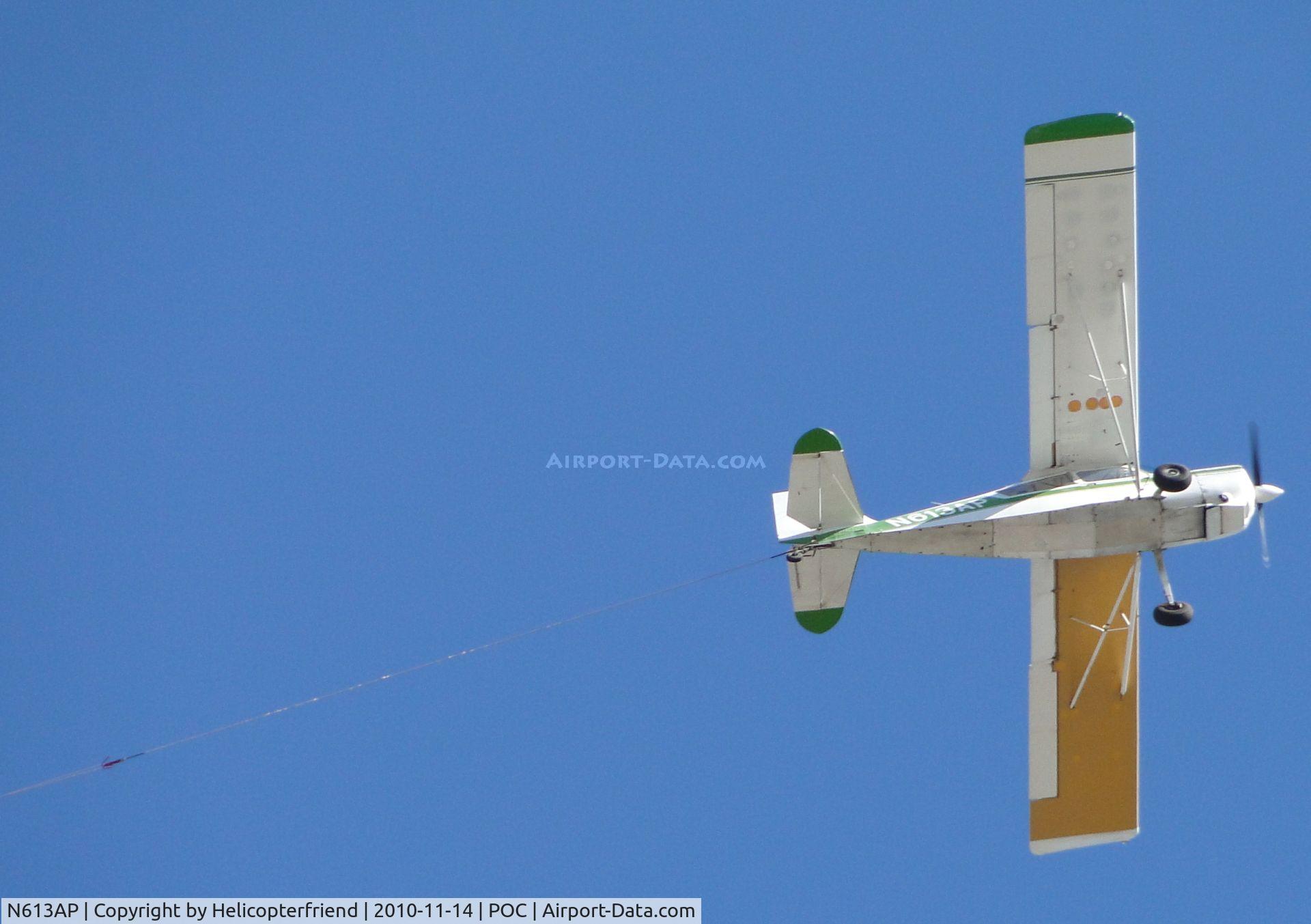 N613AP, 1976 Bellanca 8GCBC C/N 190-76, Crossing over Brackett, notice tow cable extending out from the back of the plane