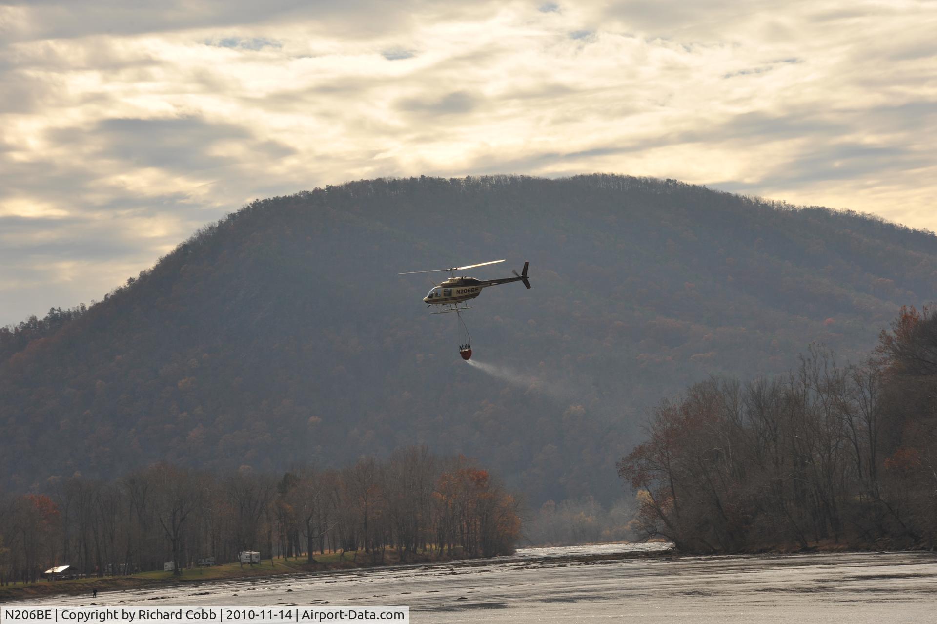 N206BE, 1978 Bell 206B JetRanger III C/N 2375, Hauling water to fight fire on mountain at McCoy Falls