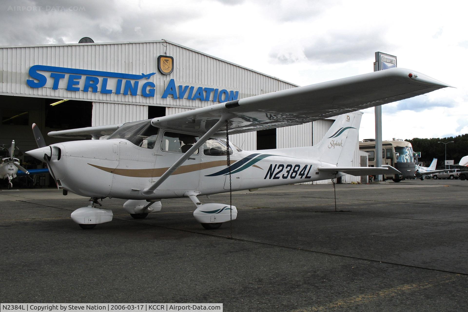N2384L, 1999 Cessna 172R C/N 17280706, Locally-based Sterling Flight Center 1999 Cessna 172R in old gold-blue-green highlight colors @ Buchanan Field, Concord, CA just before a storm