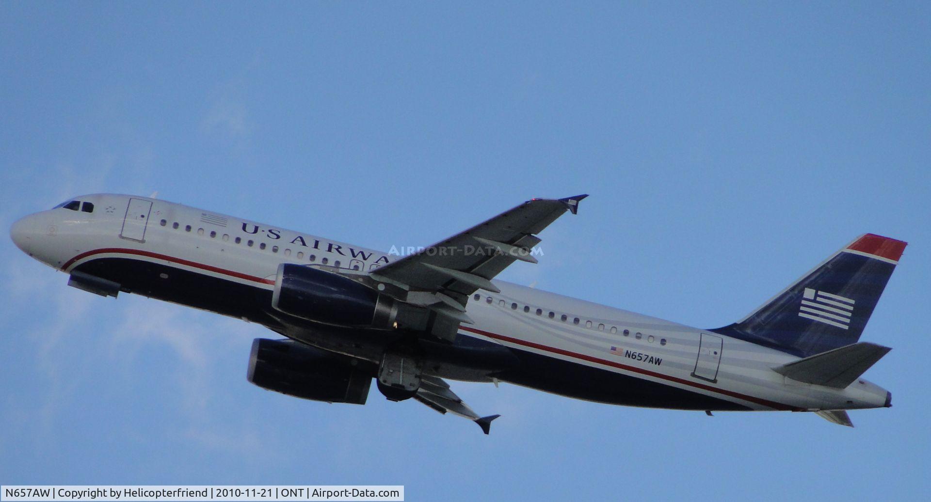 N657AW, 1999 Airbus A320-232 C/N 1083, Wheels coming up after lift off from runway 26R