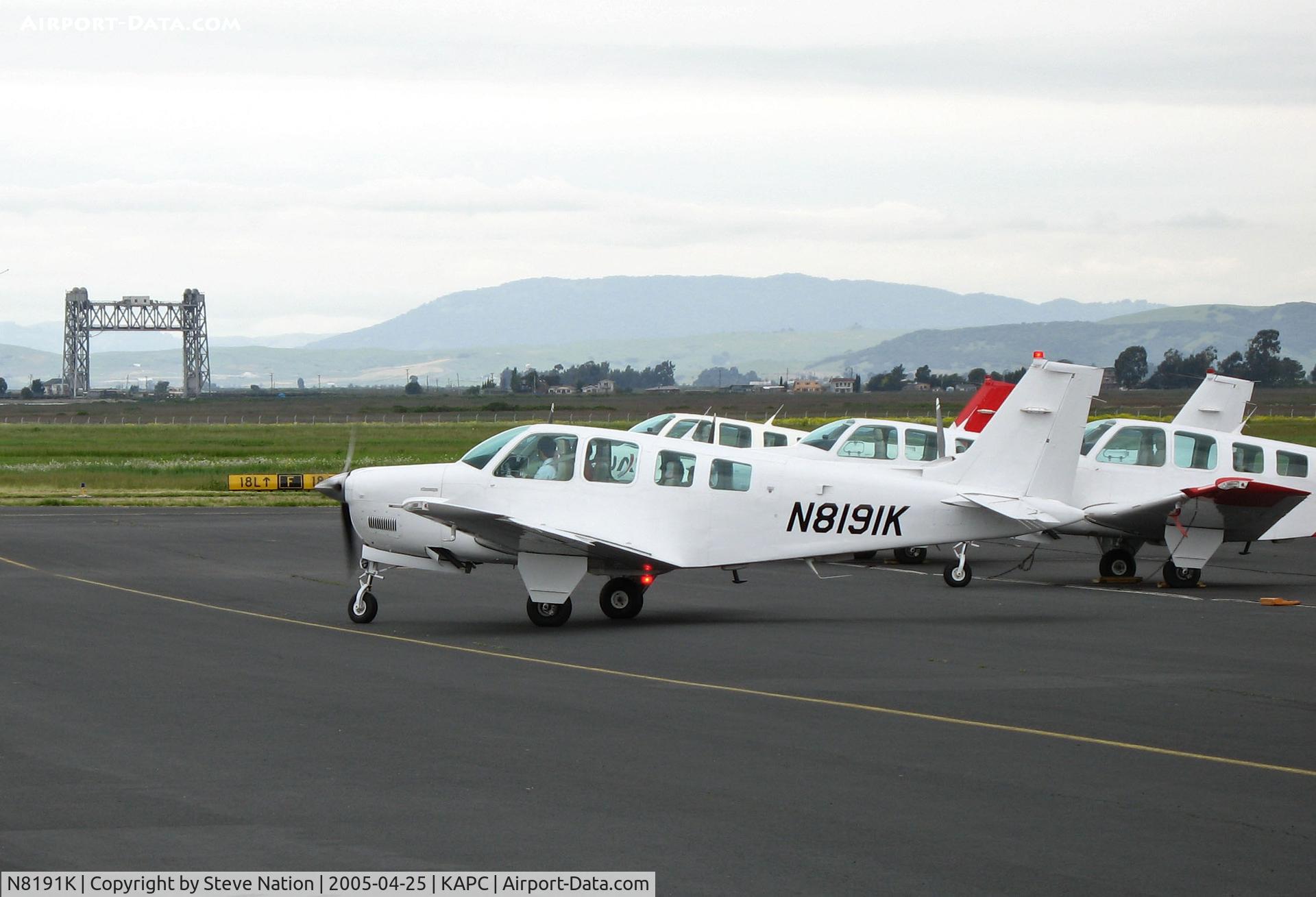 N8191K, 1991 Beech A36 Bonanza 36 C/N E-2662, All white 1991 Beech A36 operated by Japan Air Lines training unit @ Napa County Airport, CA (Napa River RR Bridge in background)