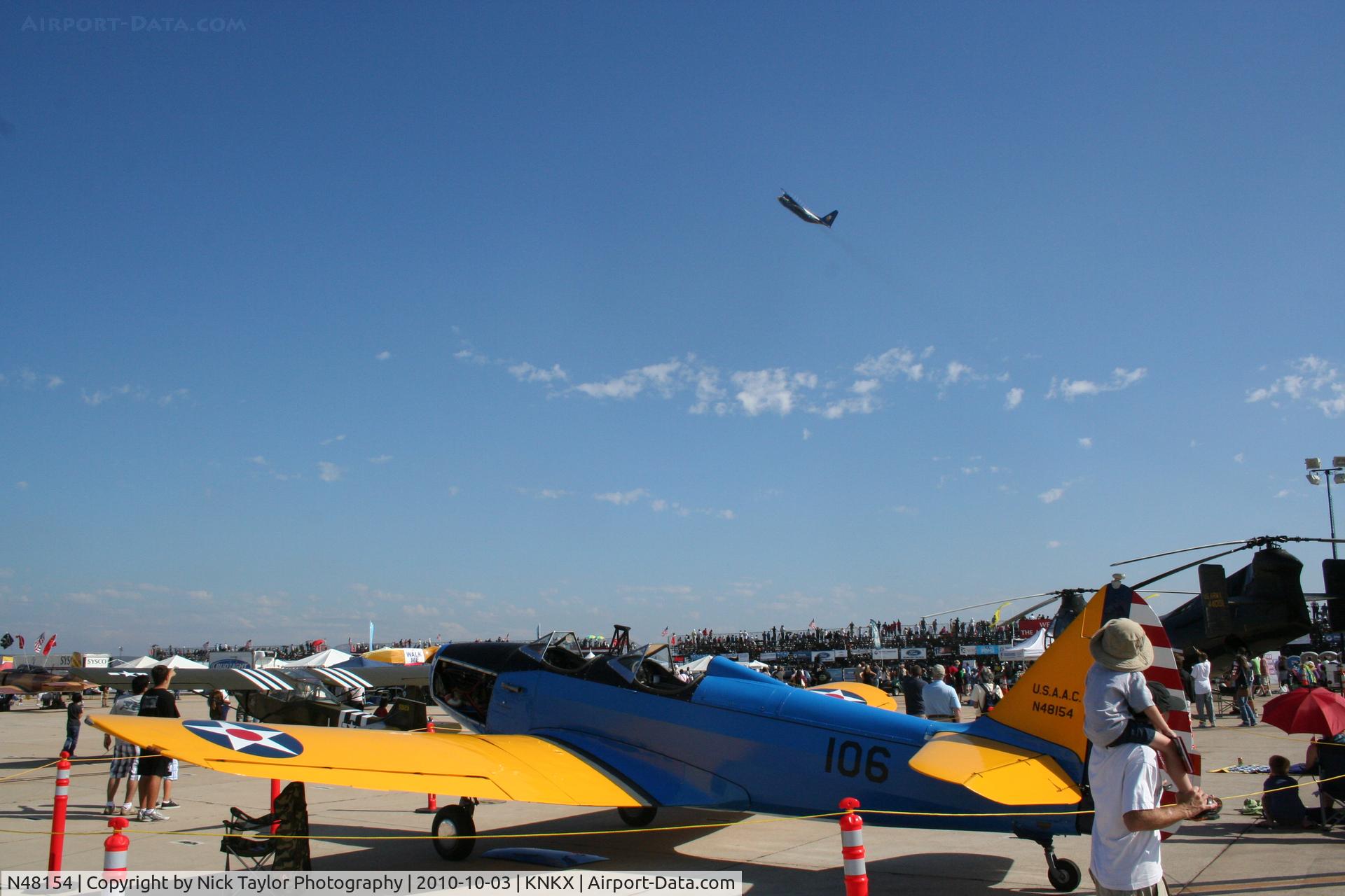 N48154, 1943 Fairchild M-62A C/N T437053, Fat Albert taking off in the background
