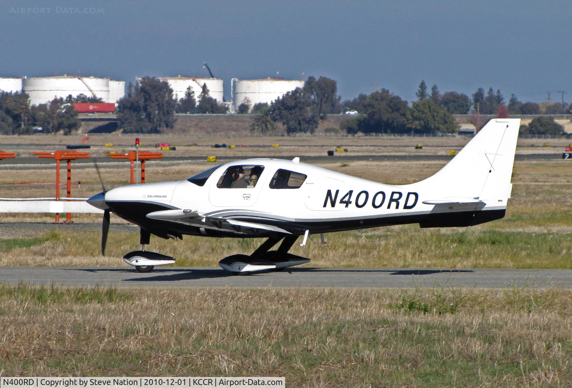 N400RD, 2005 Lancair LC41-550FG C/N 41519, Locally-based 2005 Lancair LC41-550FG Columbia 400 fast taxis to RWY 1L with oil tank farm in background @ Buchanan Field, Concord, CA