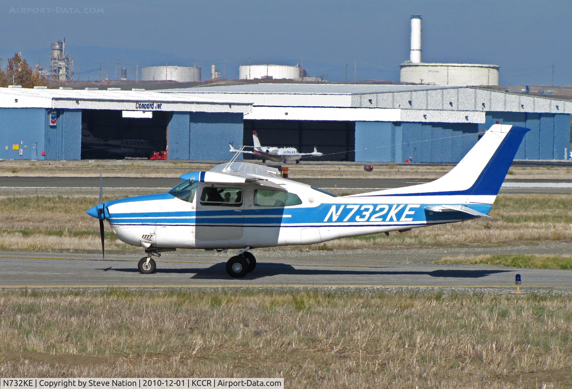 N732KE, Cessna T210L Turbo Centurion C/N 21061566, Central Valley-based Cessna T210L taxis for take-off on RWY 1L with Concord Jet hangers and tank farm in background @ Buchanan Field, Concord, CA