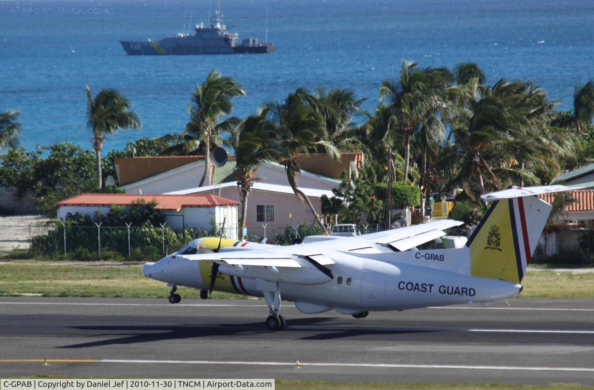C-GPAB, 1991 De Havilland Canada DHC-8-106 Dash 8 C/N 275, Coast Guard C-GPAB landing at TNCM while with the cutter in the back ground.