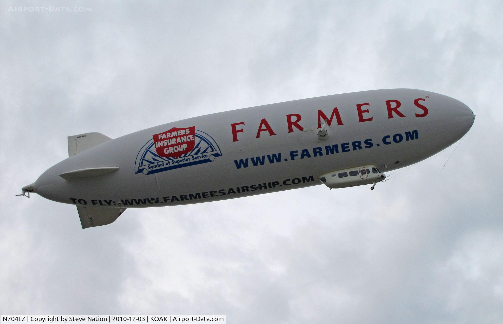 N704LZ, 2008 Zeppelin LZ N07-100 C/N 004, Airship Ventures dirigible in latest color scheme (Farmer's Insurance titles) climbing out from North Field @ Oakland International Airport, CA
