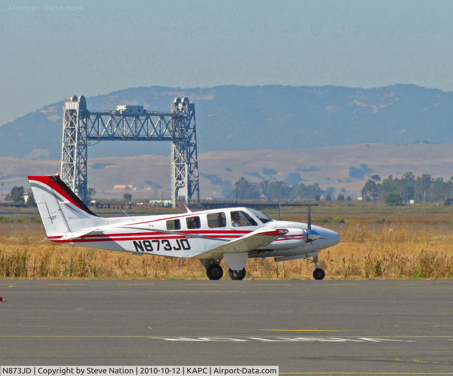 N873JD, Raytheon Aircraft Company 58 C/N TH-2044, Napa River RR Bridge says good by to Raytheon 58 with JAL titles (JAL ended 30+ year contract with IASCO at end of Oct 2010) @ Napa County Airport, CA