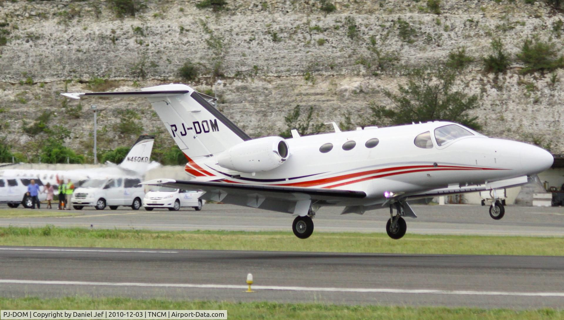 PJ-DOM, 2010 Cessna 510 Citation Mustang Citation Mustang C/N 510-0316, PJ-DOM touching down at TNCM with family friends and well wishers in the back ground. the aircraft is locally own.