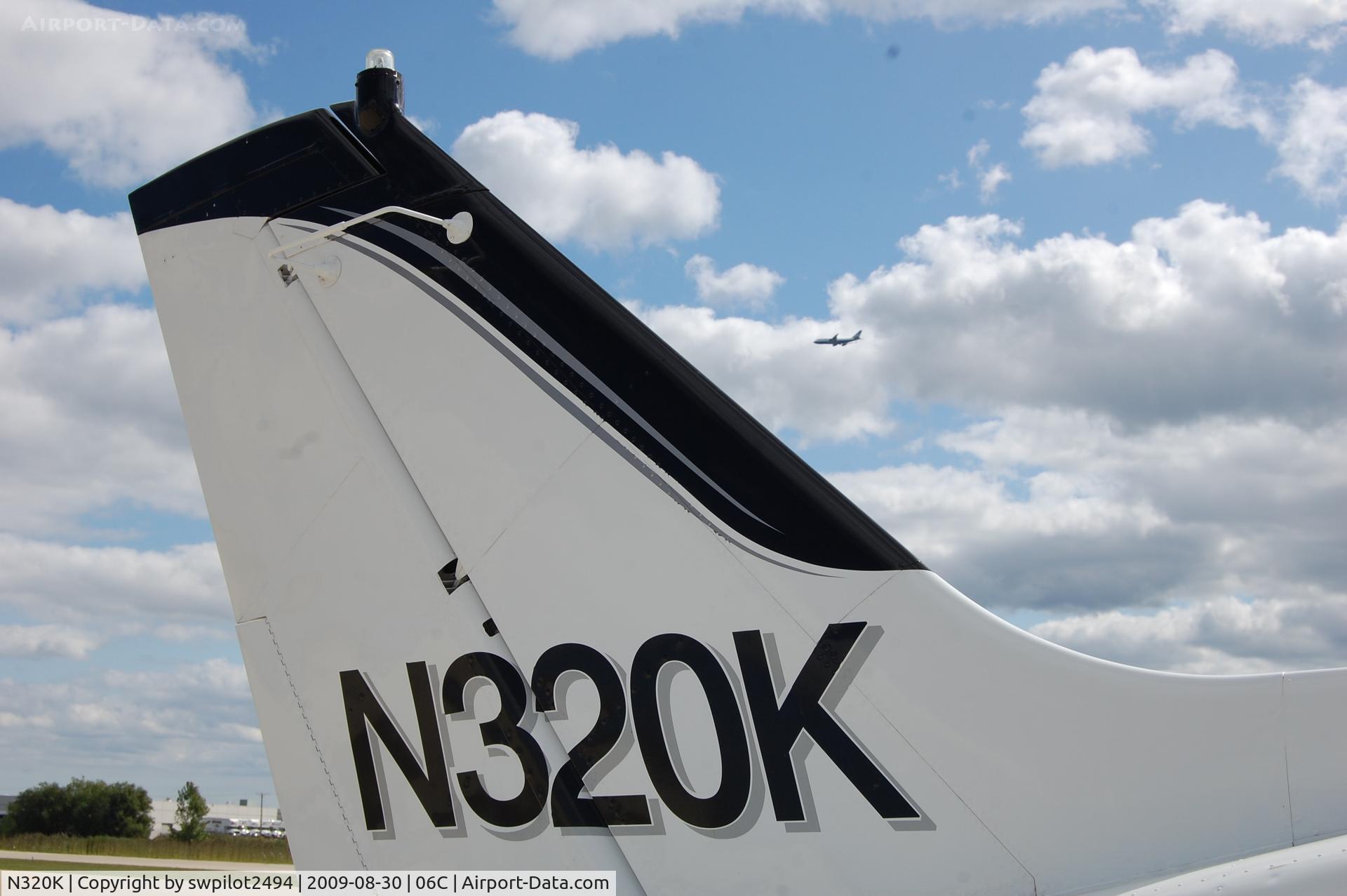 N320K, 1961 Cessna 320 Skyknight C/N 320-0018, N320K tail with a United 744 on the approach for 10 into O'hare.