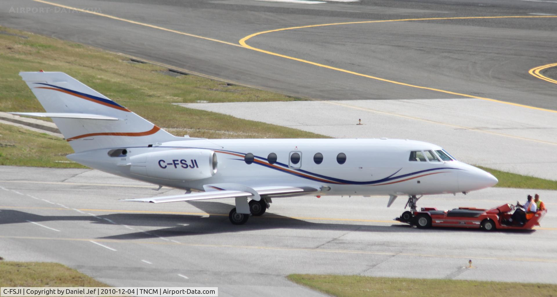 C-FSJI, 1977 Dassault Falcon (Mystere) 20F-5 C/N 373, C-FSJI being towed to the cargo ramp at TNCM