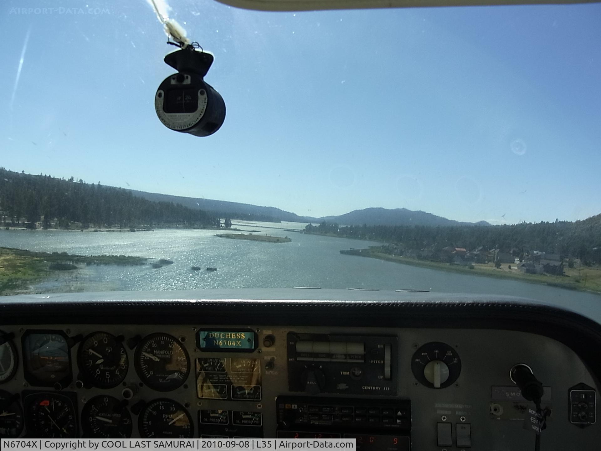 N6704X, 1979 Beech 76 Duchess C/N ME-291, Departing from Big Bear Airport, flying over the lake