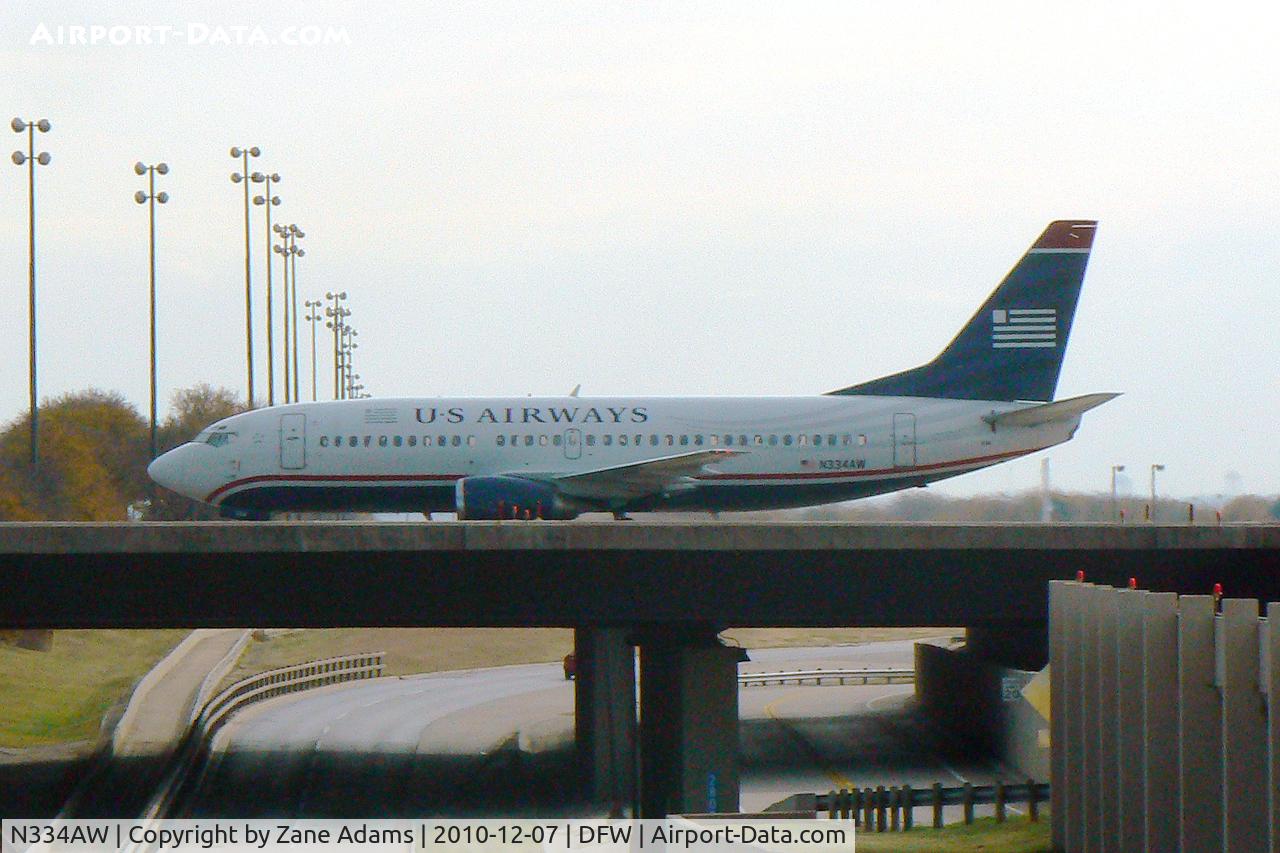 N334AW, 1987 Boeing 737-3Y0 C/N 23748, US Air crossing the south bridge at DFW Airport - TX
(taken through the windshield on the service road :)