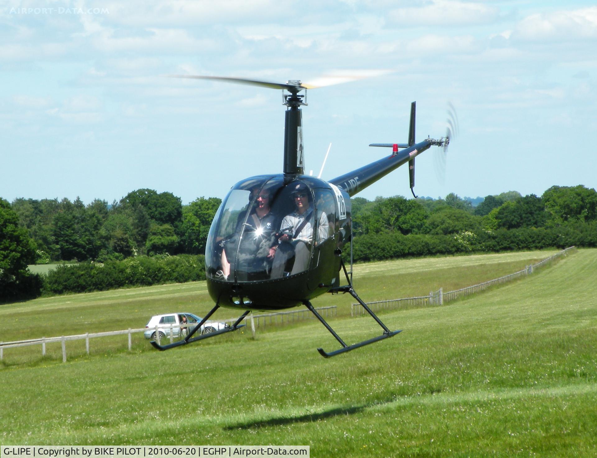 G-LIPE, 1991 Robinson R22 Beta C/N 1882, Papa Echo with competition numbers manouvering to land
