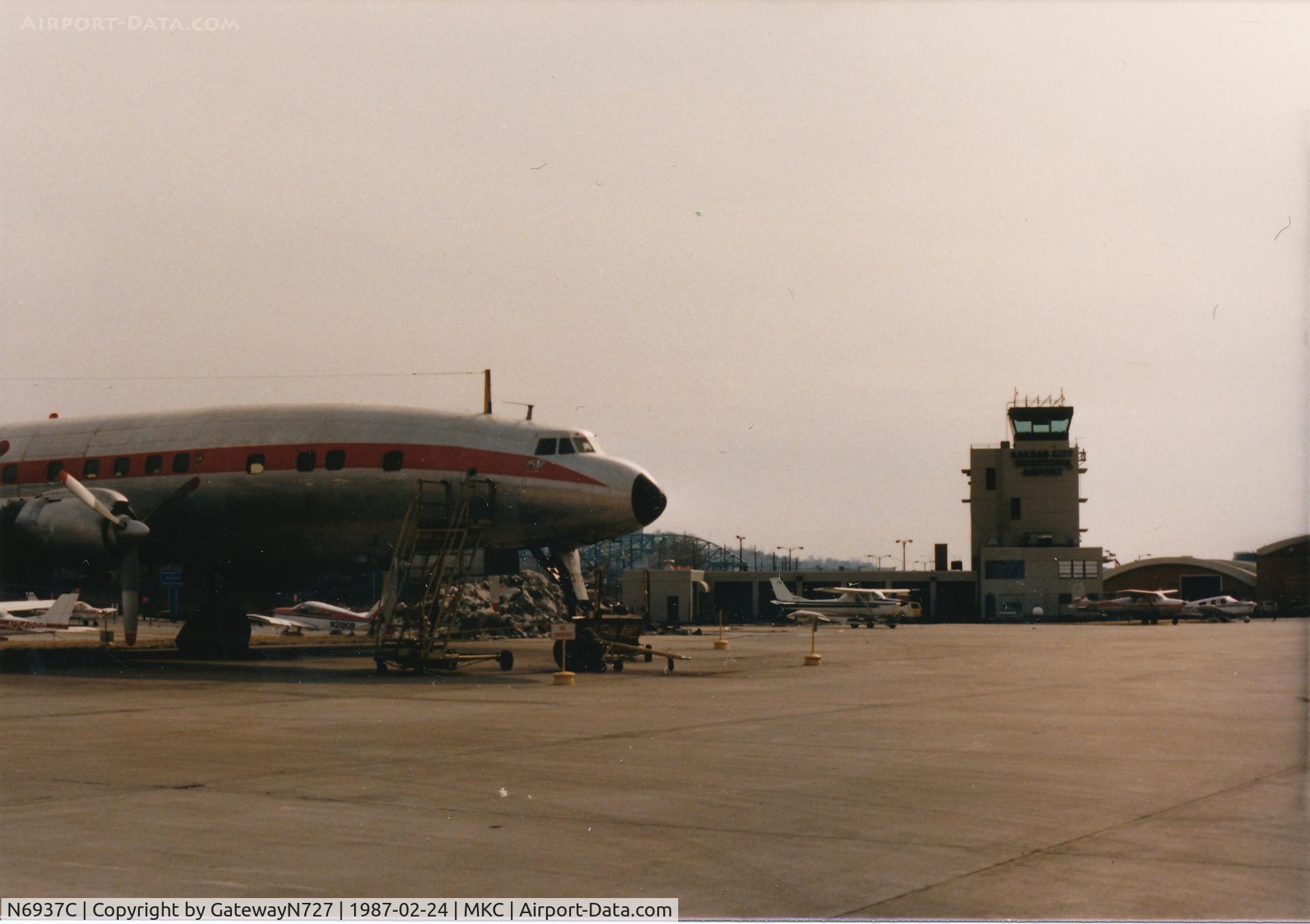 N6937C, 1957 Lockheed L-1049H-82 Super Constellation C/N 4830, Note the short nose vs. what is on the aircraft today. MKC tower in the background.