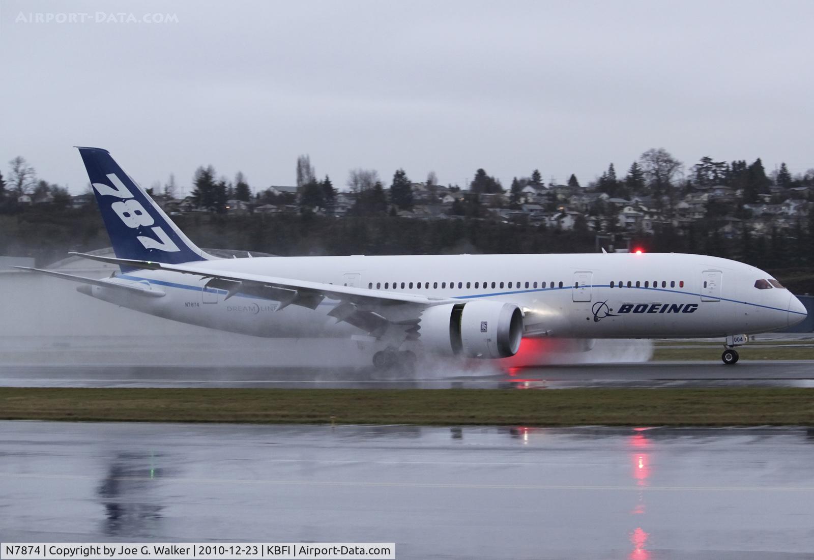 N7874, 2009 Boeing 787-8 Dreamliner C/N 40693, Dec. 23, 2010, marked the resumption of 787 flight testing since the infamous Laredo incident. Seen rolling out at a very soggy BFI is ZA004, 
