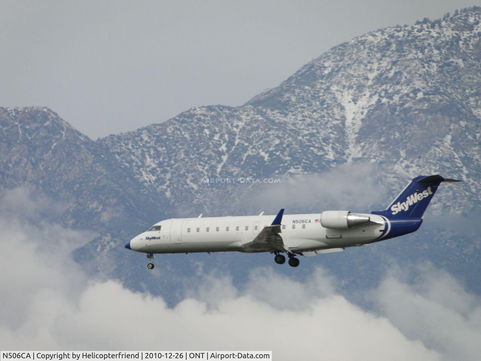 N506CA, 2003 Bombardier CRJ-200ER (CL-600-2B19) C/N 7793, Flt 4756 from Salt Lake City, Utah, on final to land on runway 26R during a cloudy, cold day
