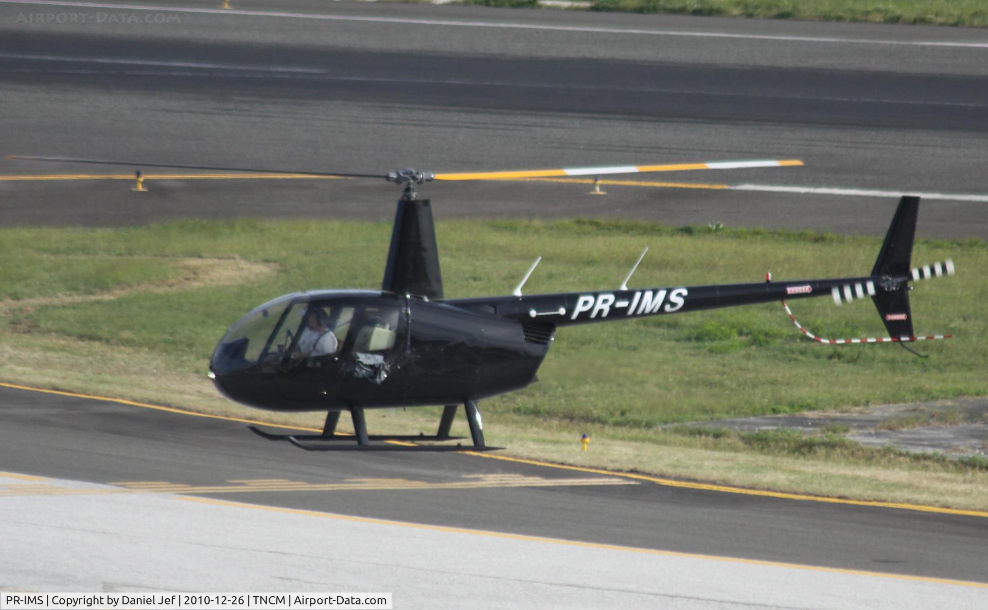 PR-IMS, Robinson R44 Raven II C/N 13054, PR-IMS holding at the taxiway Bravo for landing at TNCM