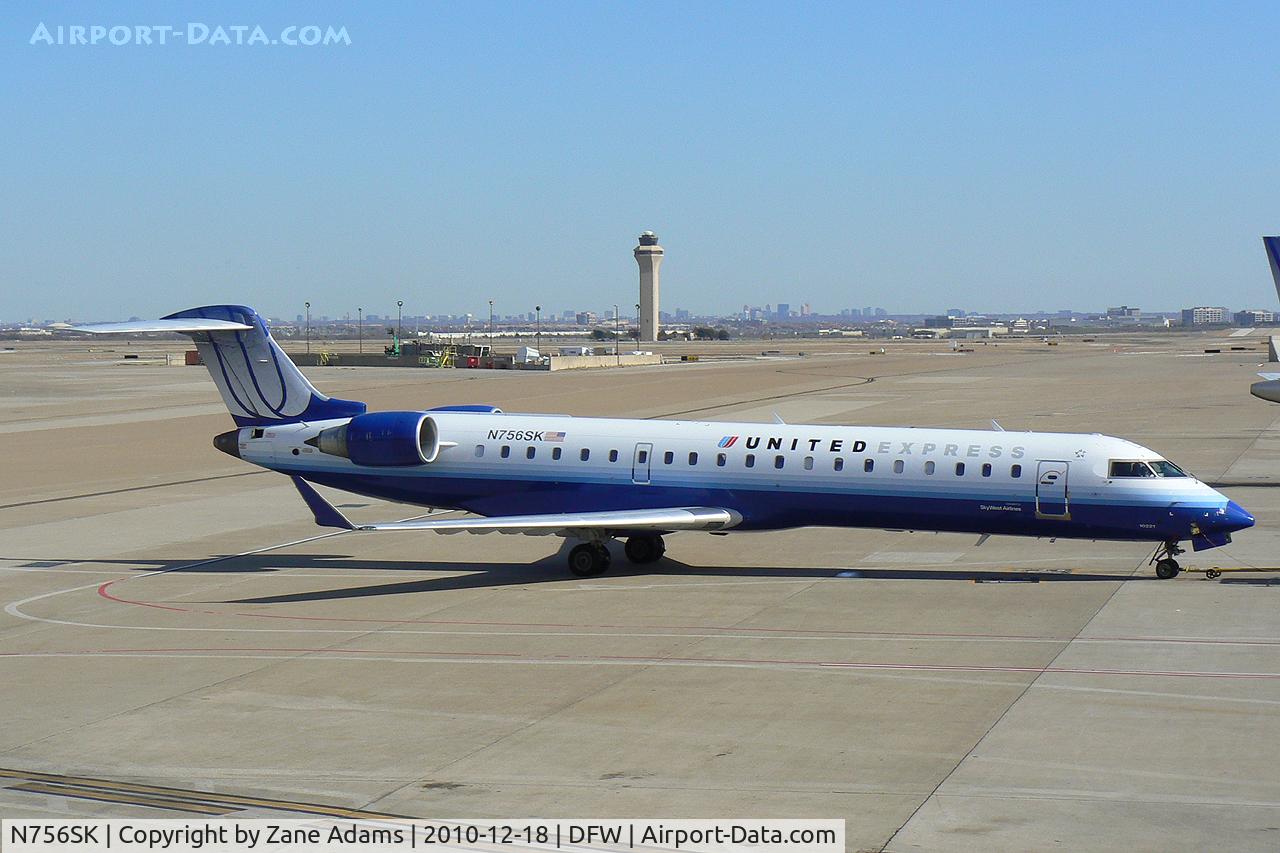 N756SK, 2005 Bombardier CRJ-701ER (CL-600-2C10) Regional Jet C/N 10221, United Express pushing back from the gate at DFW Airport