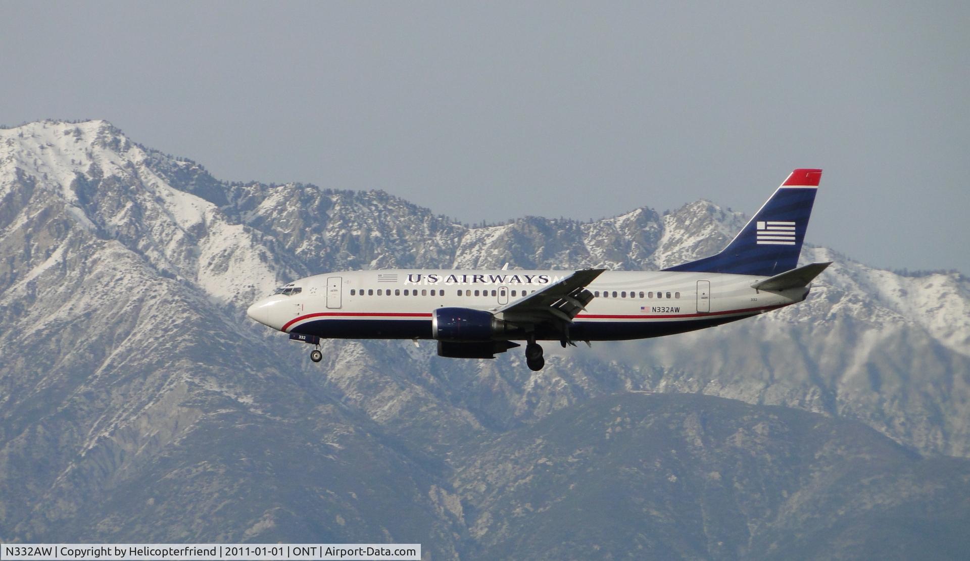 N332AW, 1987 Boeing 737-3B7 C/N 23384, Passing the snow capped peaks while on final to runway 26R