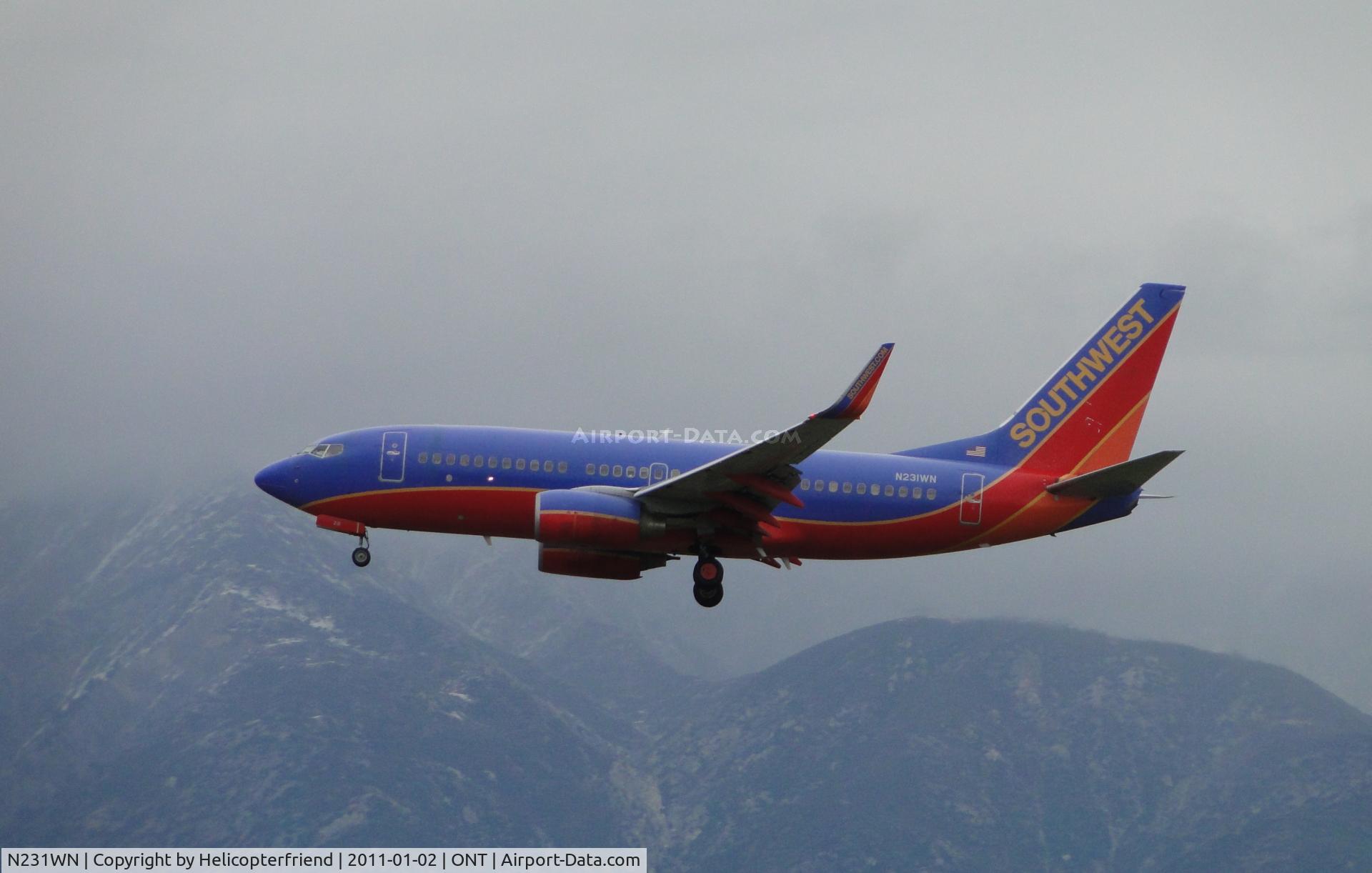 N231WN, 2006 Boeing 737-7H4 C/N 32499, Passing the snowy peaks enroute to landing on runway 26R