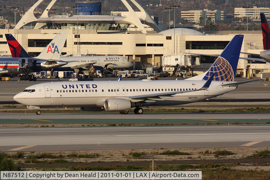 N87512, 2008 Boeing 737-824 C/N 33458, United Airlines N87512 (FLT COA17) holding short of RWY 25R on Taxiway Papa after arrival on RWY 25L from Newark Liberty Intl (KEWR). New United titles.