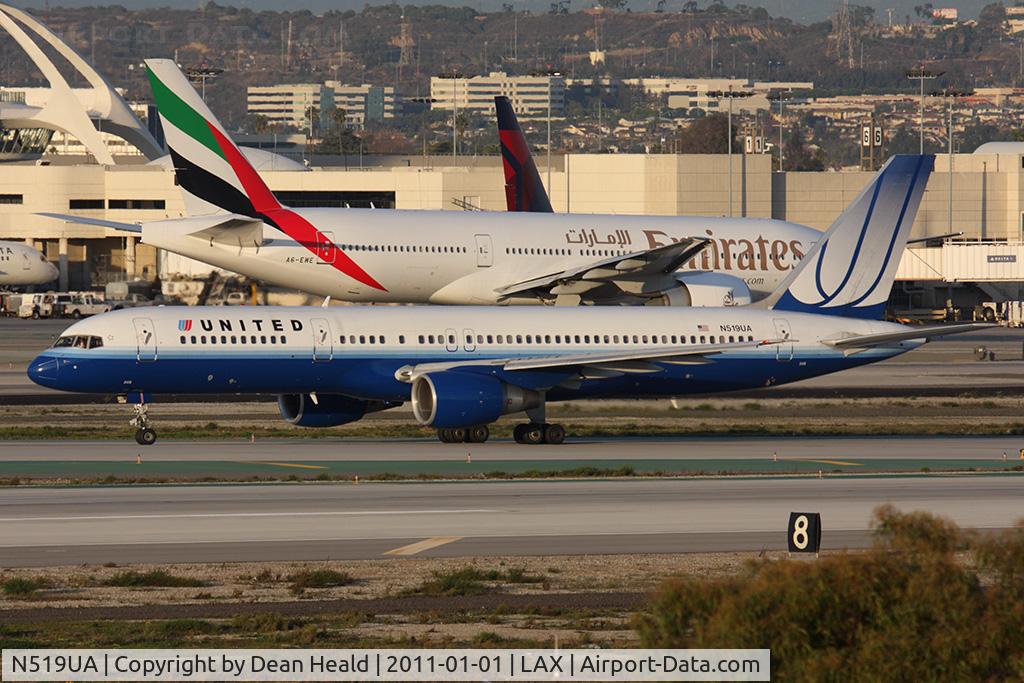 N519UA, 1990 Boeing 757-222 C/N 24872, 20 Years Old - United Airlines N519UA (FLT UAL69) on Taxiway Papa holding short of RWY 25R after arrival from Dever Intl (KDEN) on RWY 25L, with Emirates A6-EWE taxiing to RWY 25R for departure to Dubai.